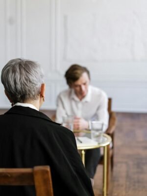 A therapist conducting a counseling session with a patient in a serene office setting.